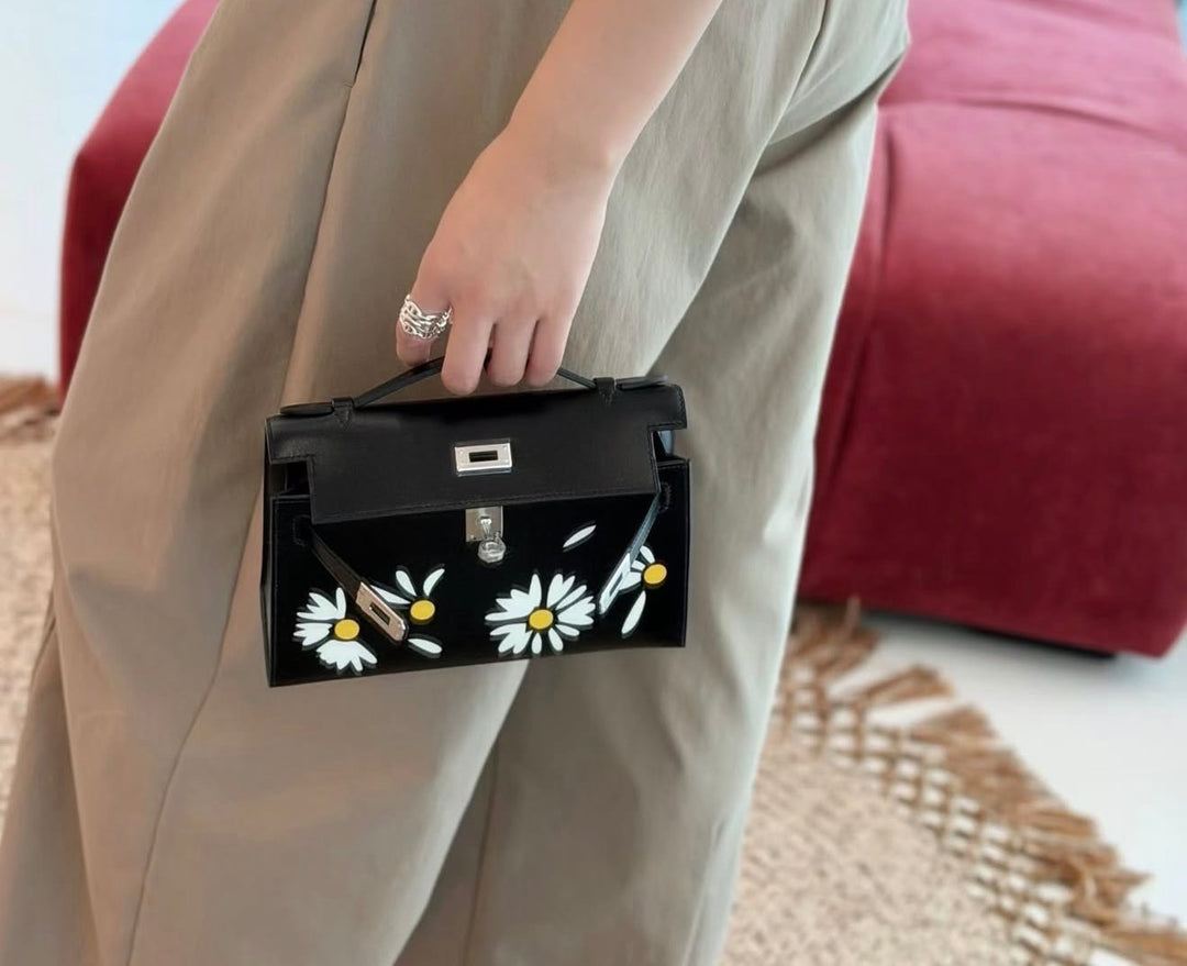 Hermès Kelly Pochette Daisy Black Box Leather White and Jaune Chèvre Inlay Palladium Hardware 2026
